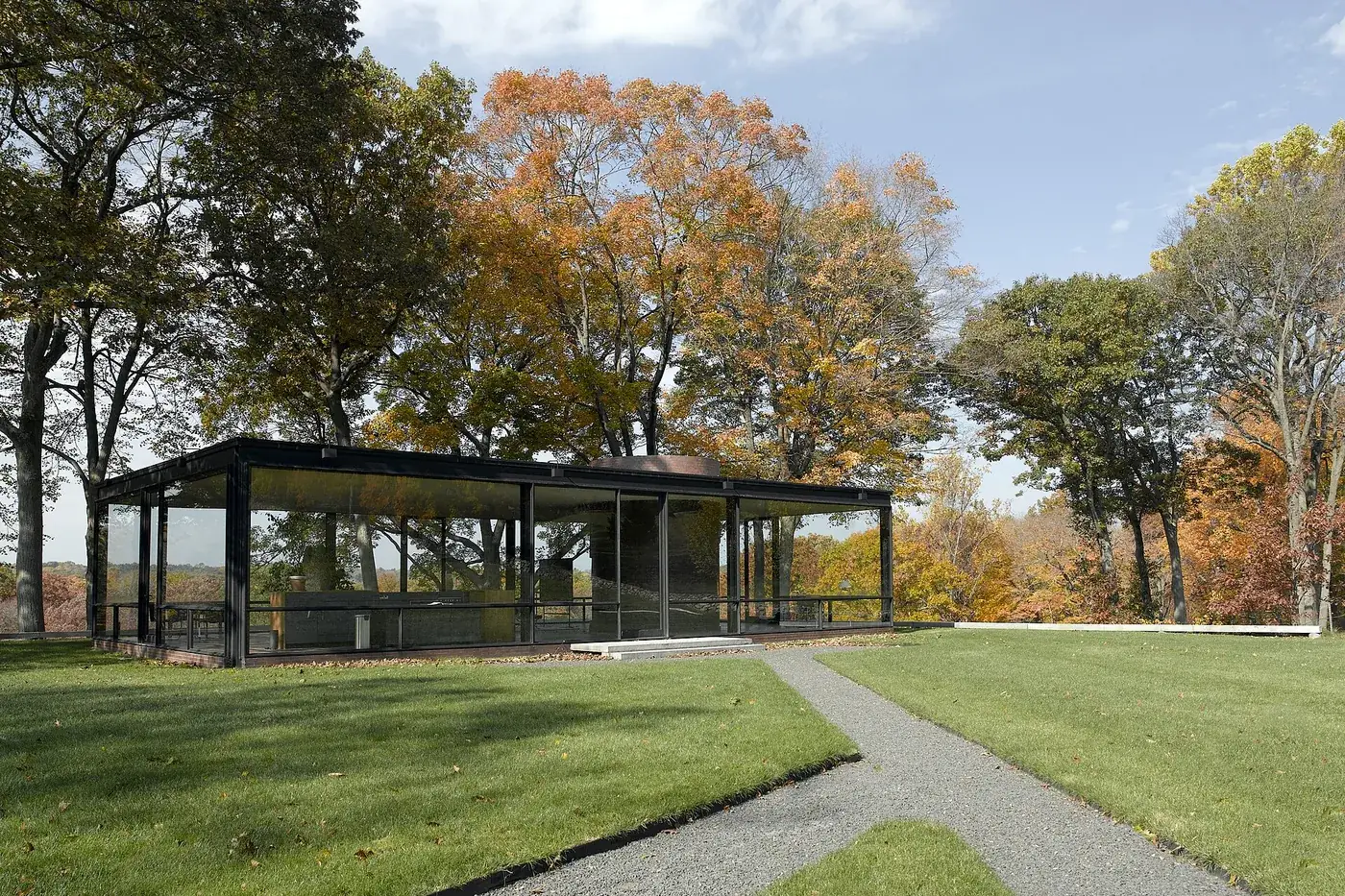 The Glass House in New Canaan, Connecticut, surrounded by autumn trees