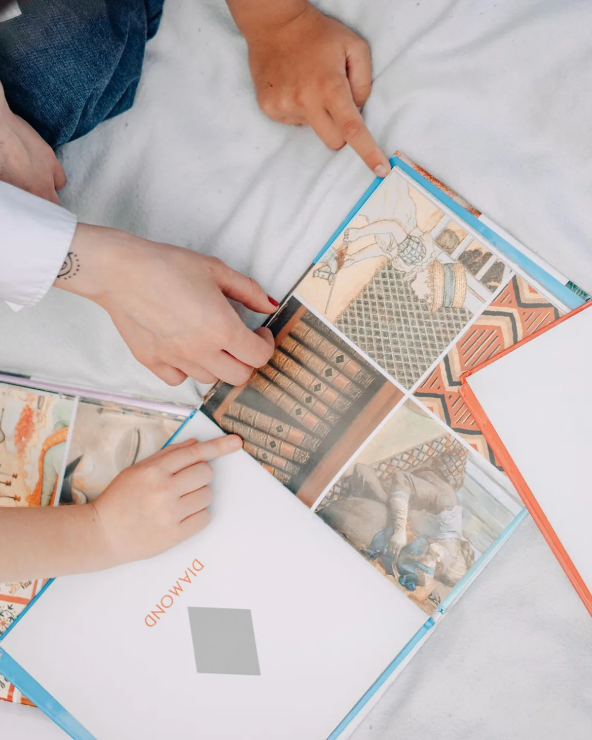 An adult and a child turning the pages of a picture book together